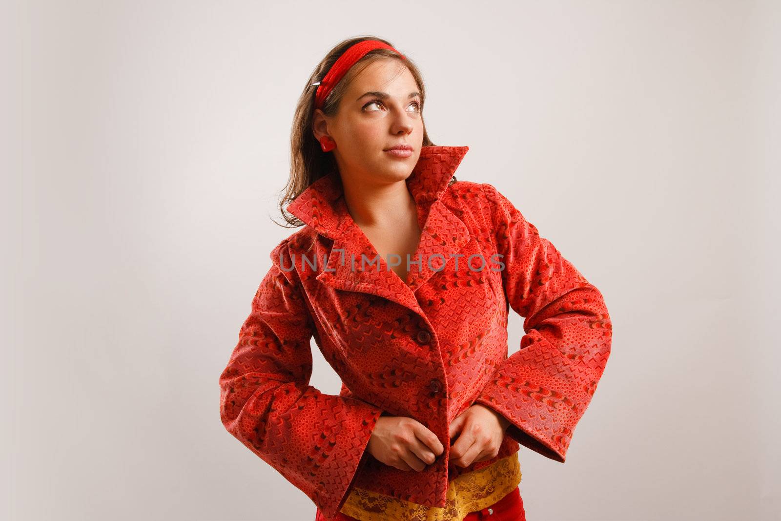 Modern looking young woman wearing a red jacket