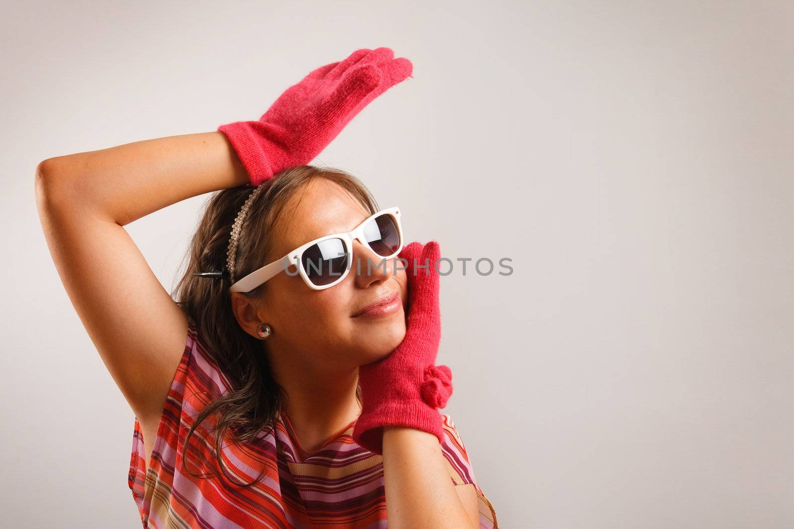 Modern looking young woman wearing sun glasses