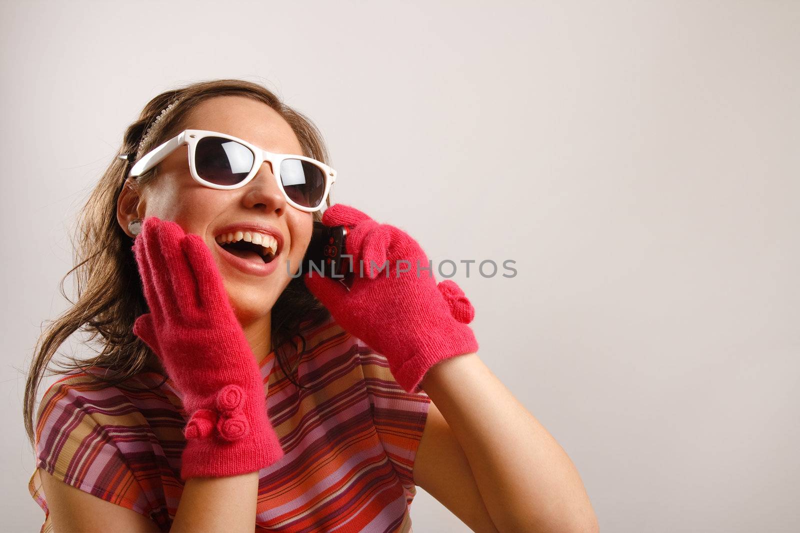 Modern looking young woman wearing sun glasses