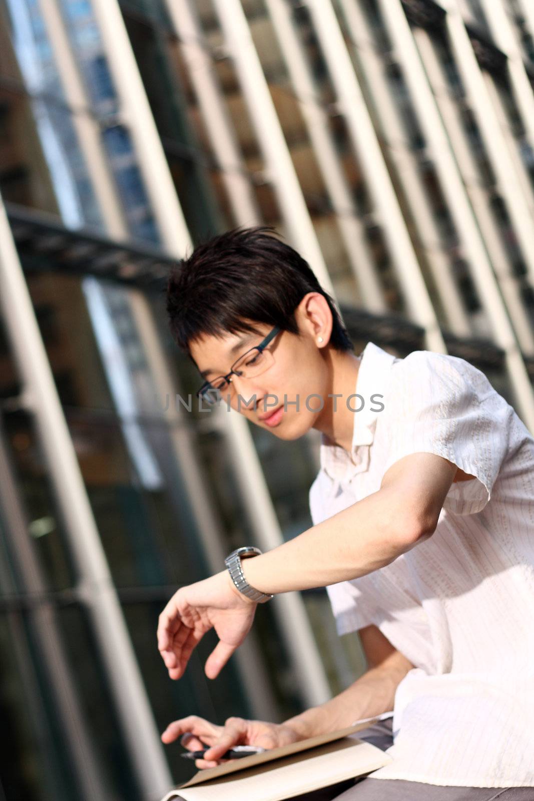 asia handsome business man looking at watch 