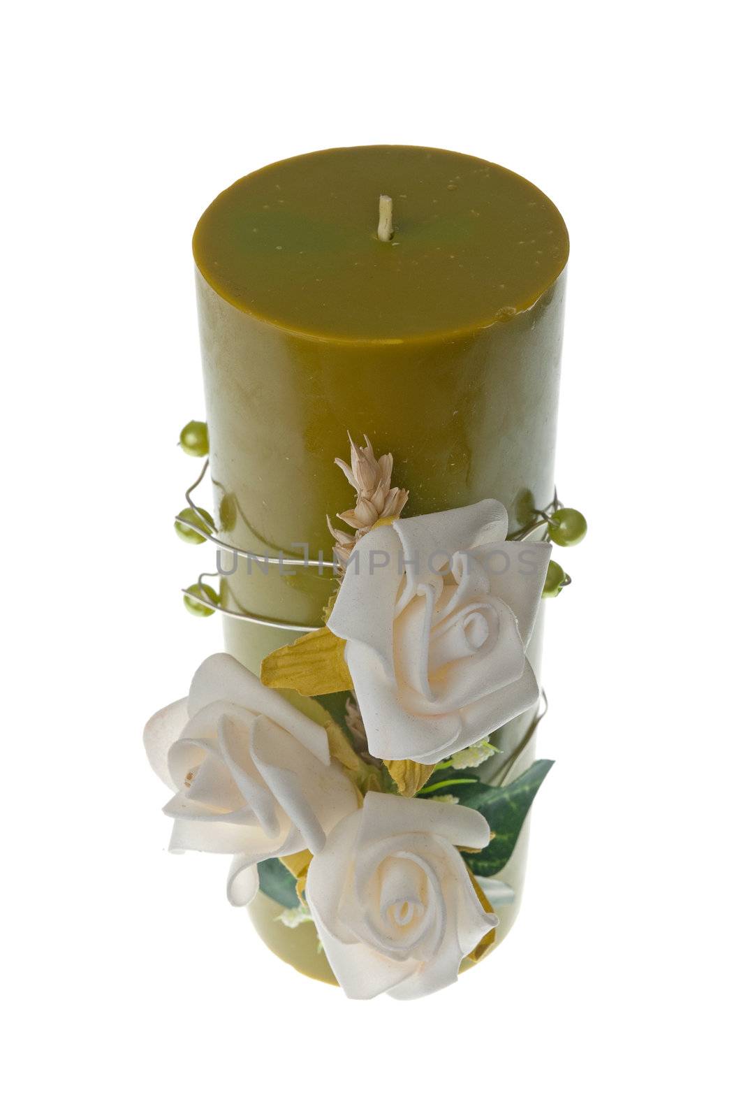 Large green candle with the flower decoration isolated on white background.