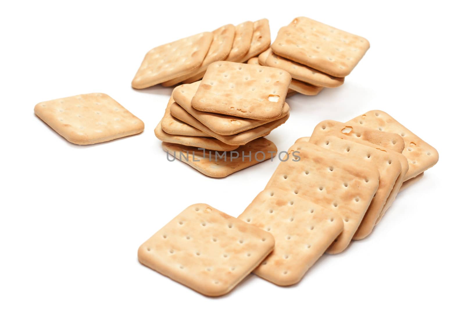Crackers put by pile on white background