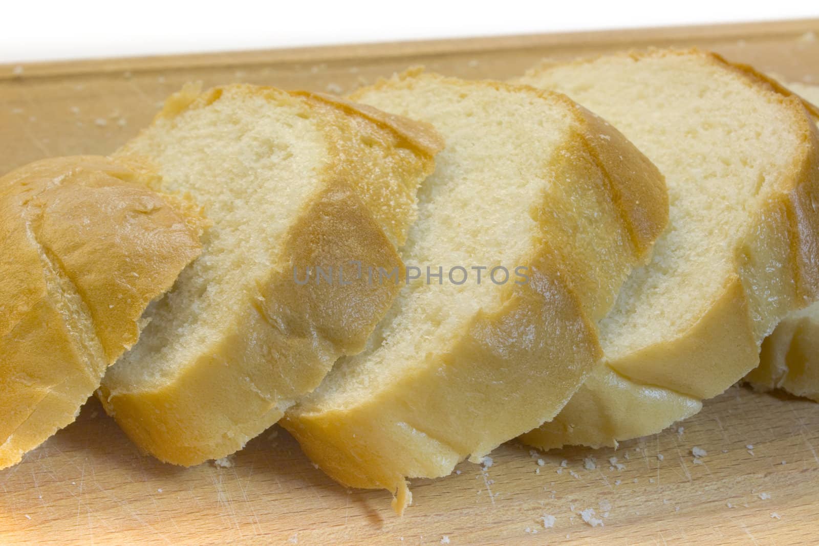 Bread on a chopping board, a photo close up on a white background