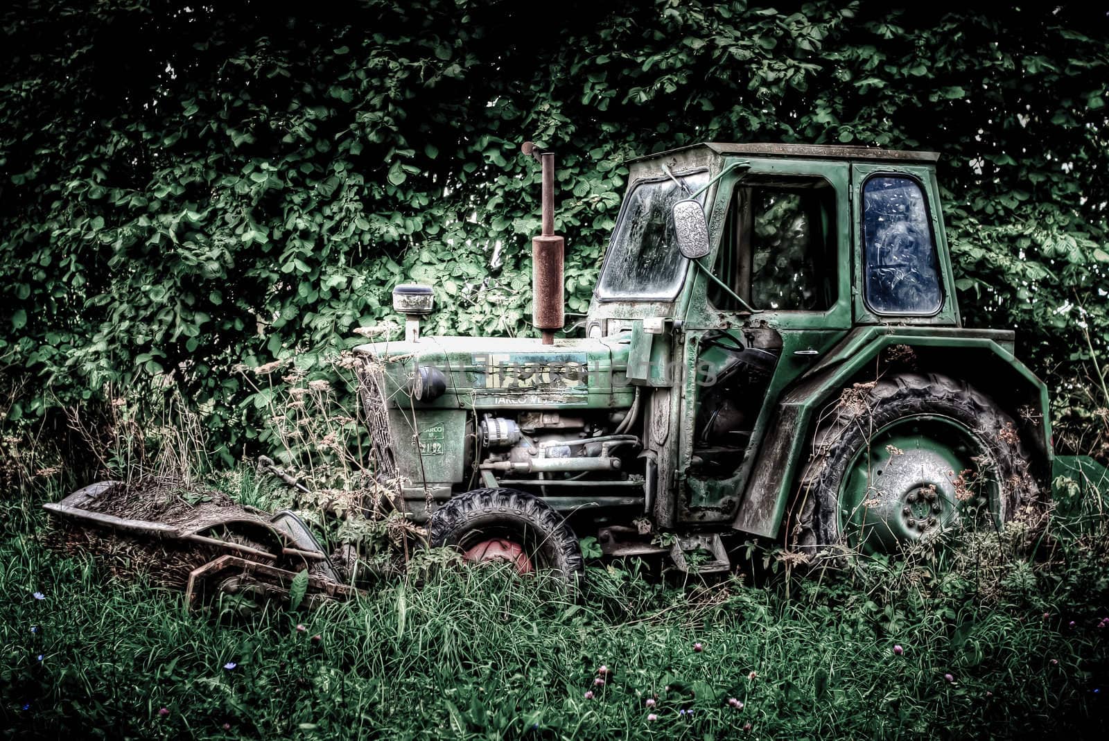 A abandoned tracktor surrounded with green trees and grass. HDRi