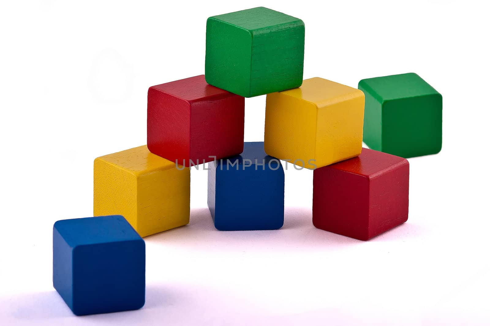 Colorful wooden toy building blocks isolated on white background