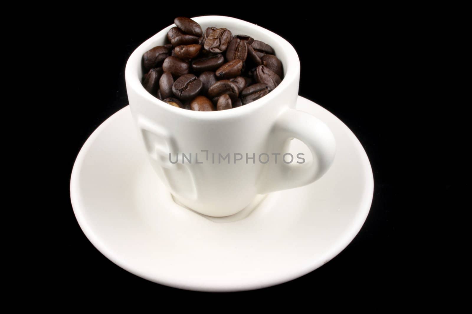 Coffee Cup with coffee beans in it on a Black Background
