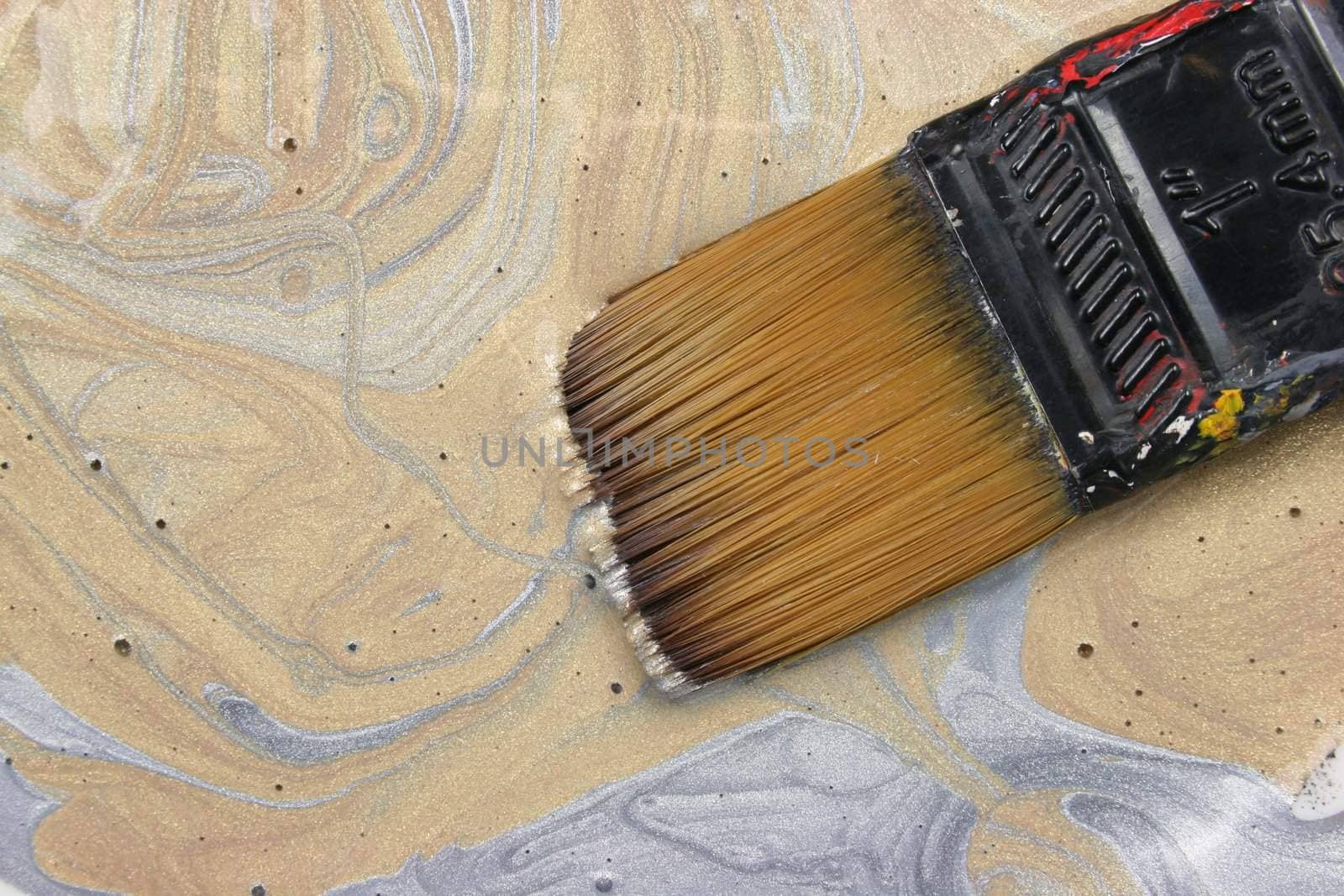 Paint brush in gold paint
