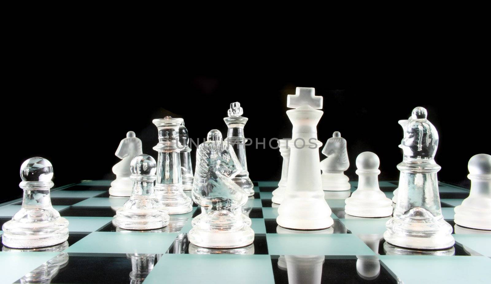 Glass Chess Pieces on a Frosted Glass Chess Board

