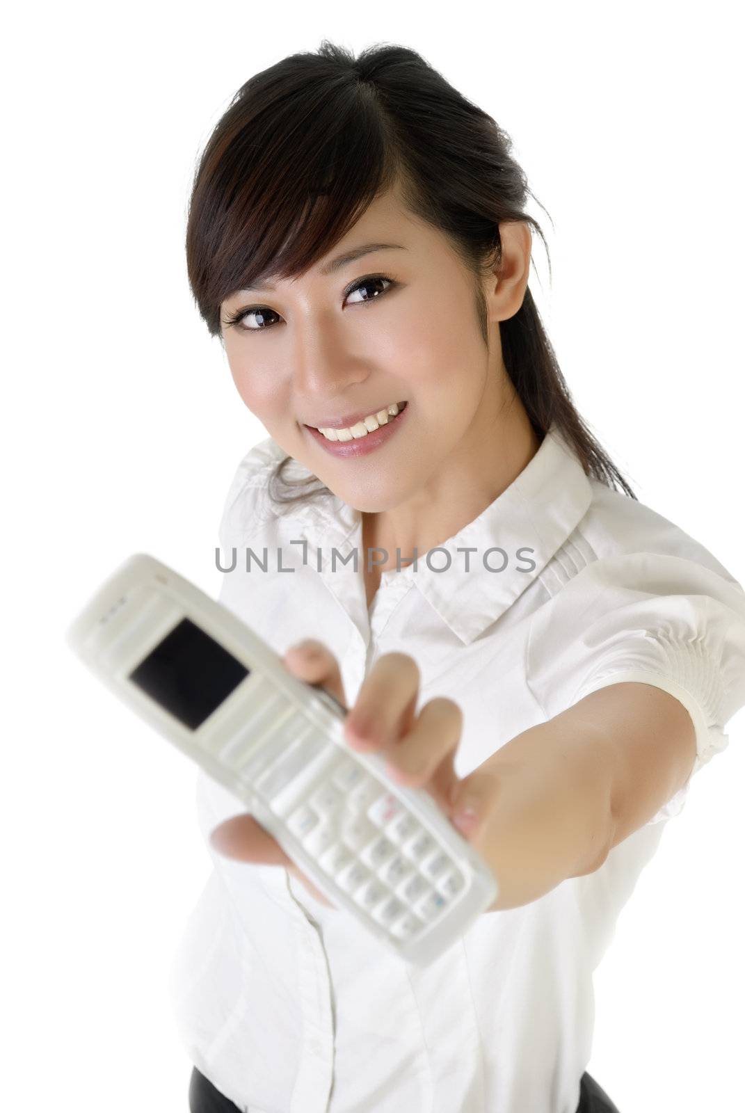 Smiling business woman showing cellphone at you on white background.