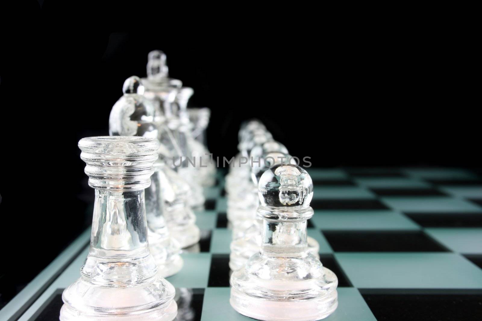 Glass Chess Pieces on a Frosted Glass Chess Board

