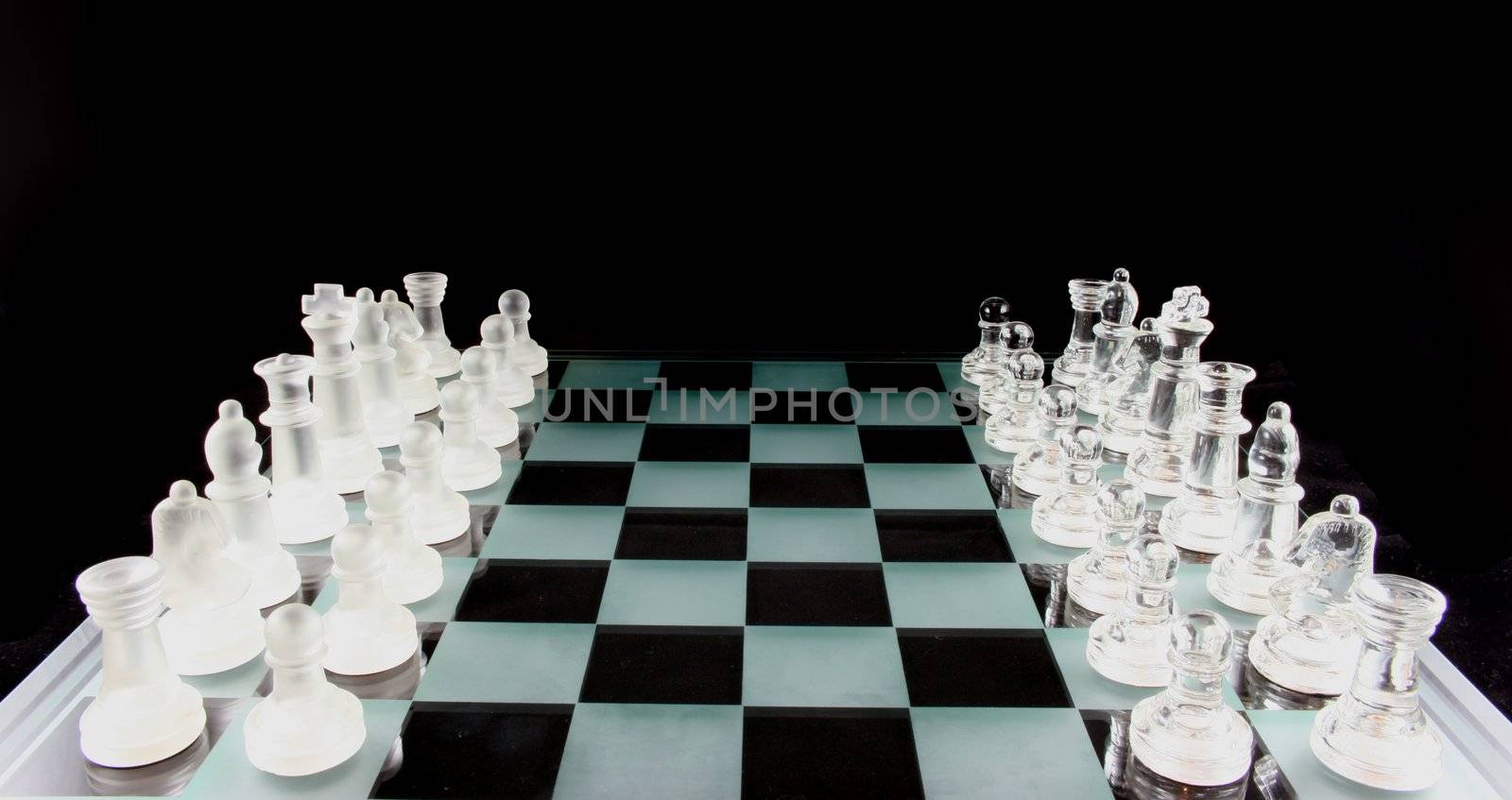 Glass Chess Pieces on a Frosted Glass Chess Board

