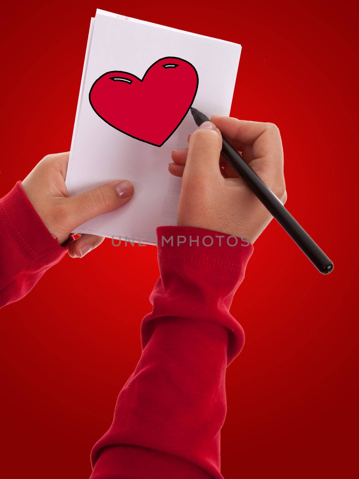 woman drawing a valentine red heart by mlopes