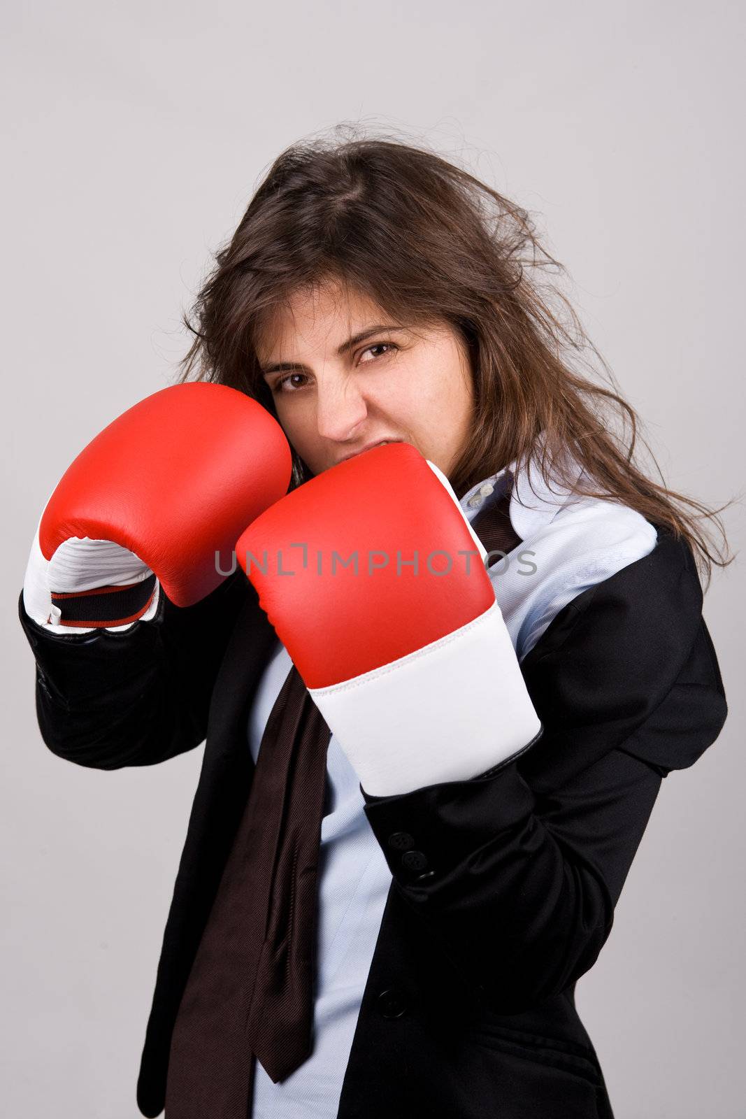 businesswoman wearing boxing gloves with confident attitude by mlopes