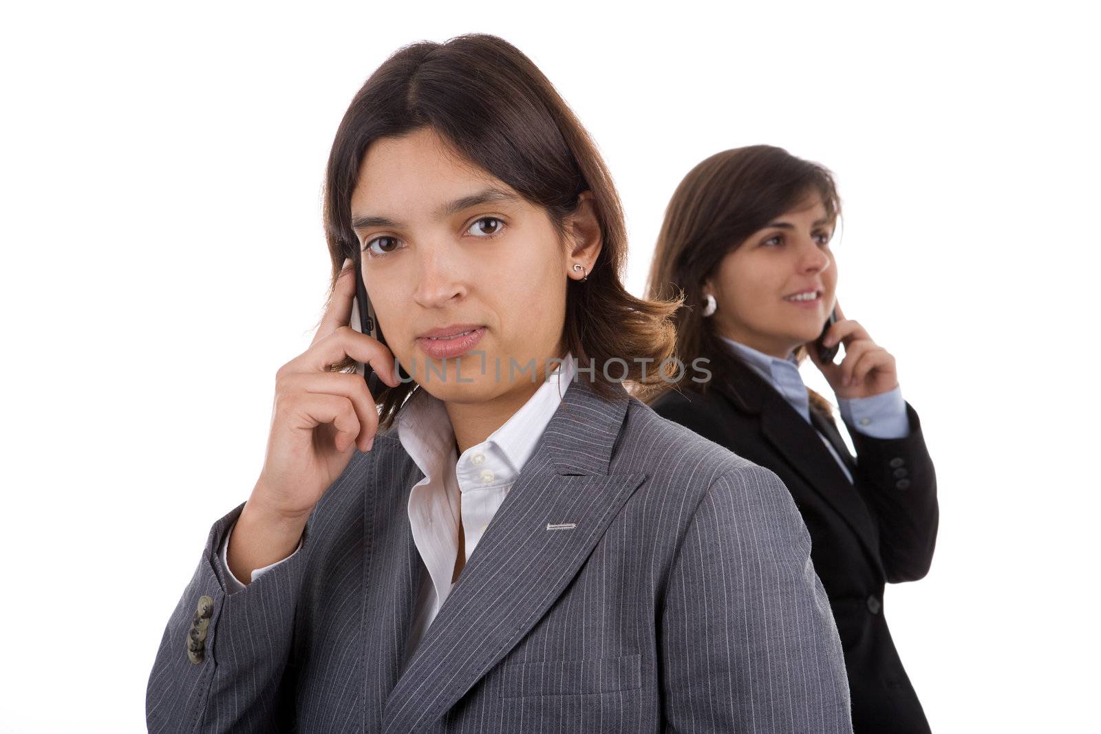 two businesswoman holding mobile phones. focus in on the front model.
