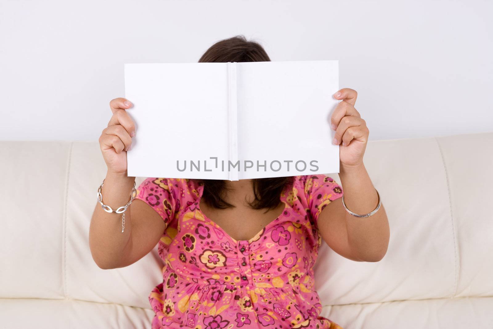 young woman reading white book by mlopes