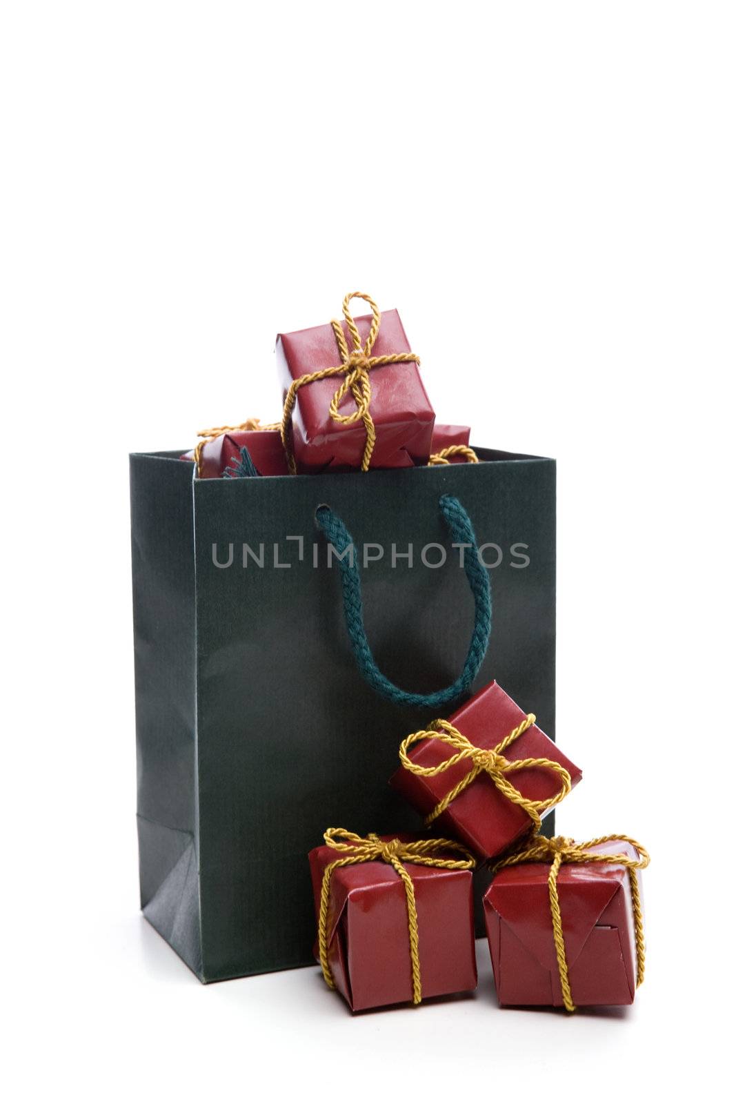 green bag with small christmas present box isolated on white background