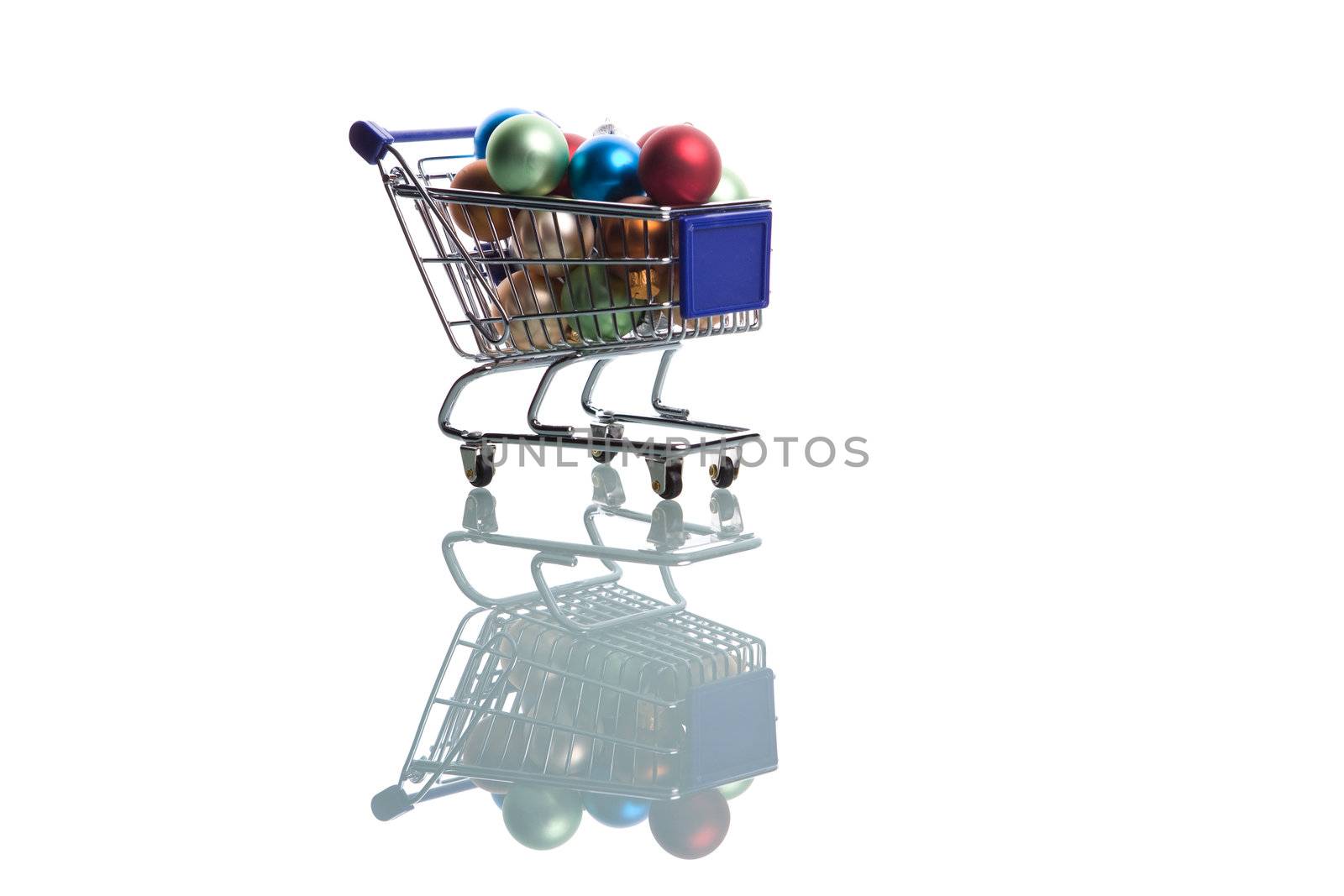 shopping cart full with christmas balls isolated on white background