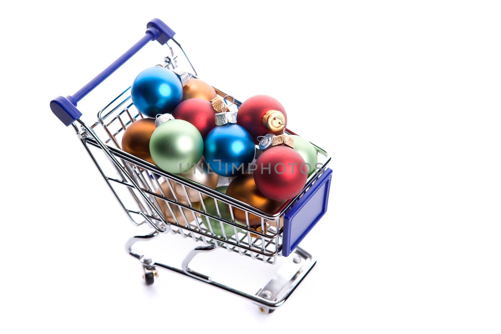 shopping cart full with colorfull christmas balls isolated on white background