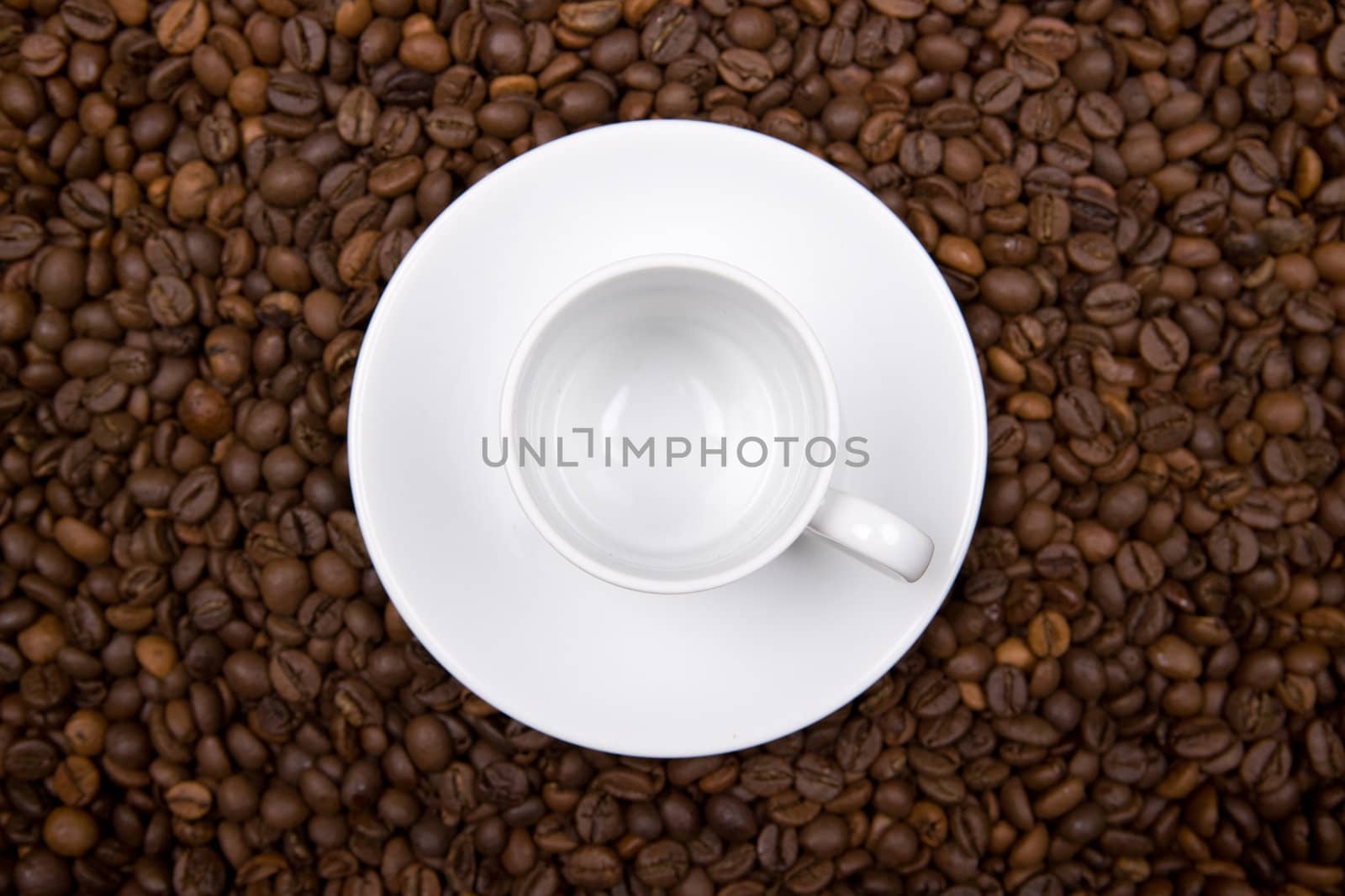 white cup over coffee bean made background. landscape orientation.