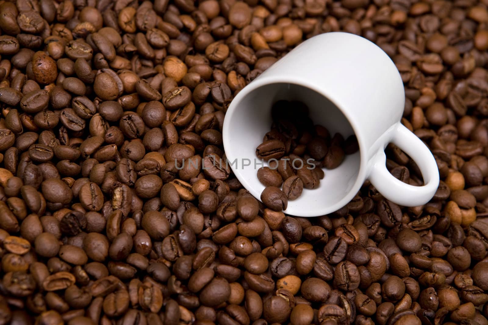 white cup over coffee bean made background by mlopes