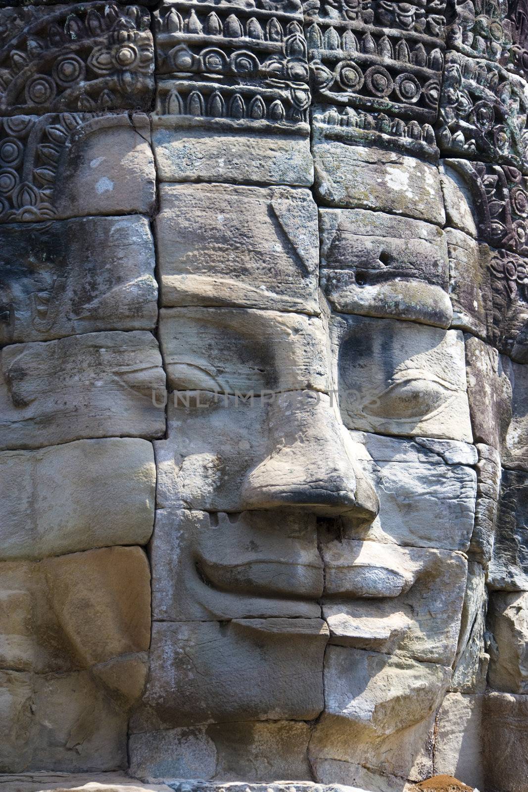 Image of Buddha's face at UNESCO's World Heritage Site of Bayon, which is part of the larger temple complex of Angkor Thom, located at Siem Reap, Cambodia. This is one of the temples in Siem Reap where the Hollywood movie Lara Croft Tomb Raider was filmed at.