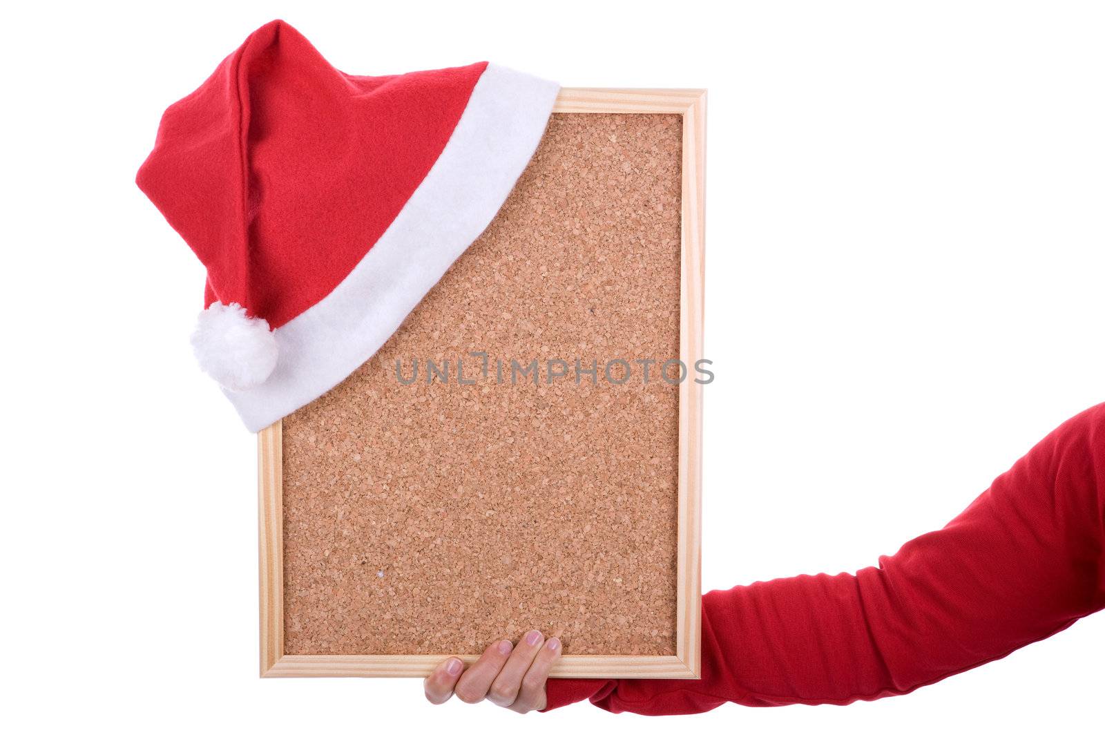 hand holding empty frame with red santa hat. isolated on white background. landscape orientation.