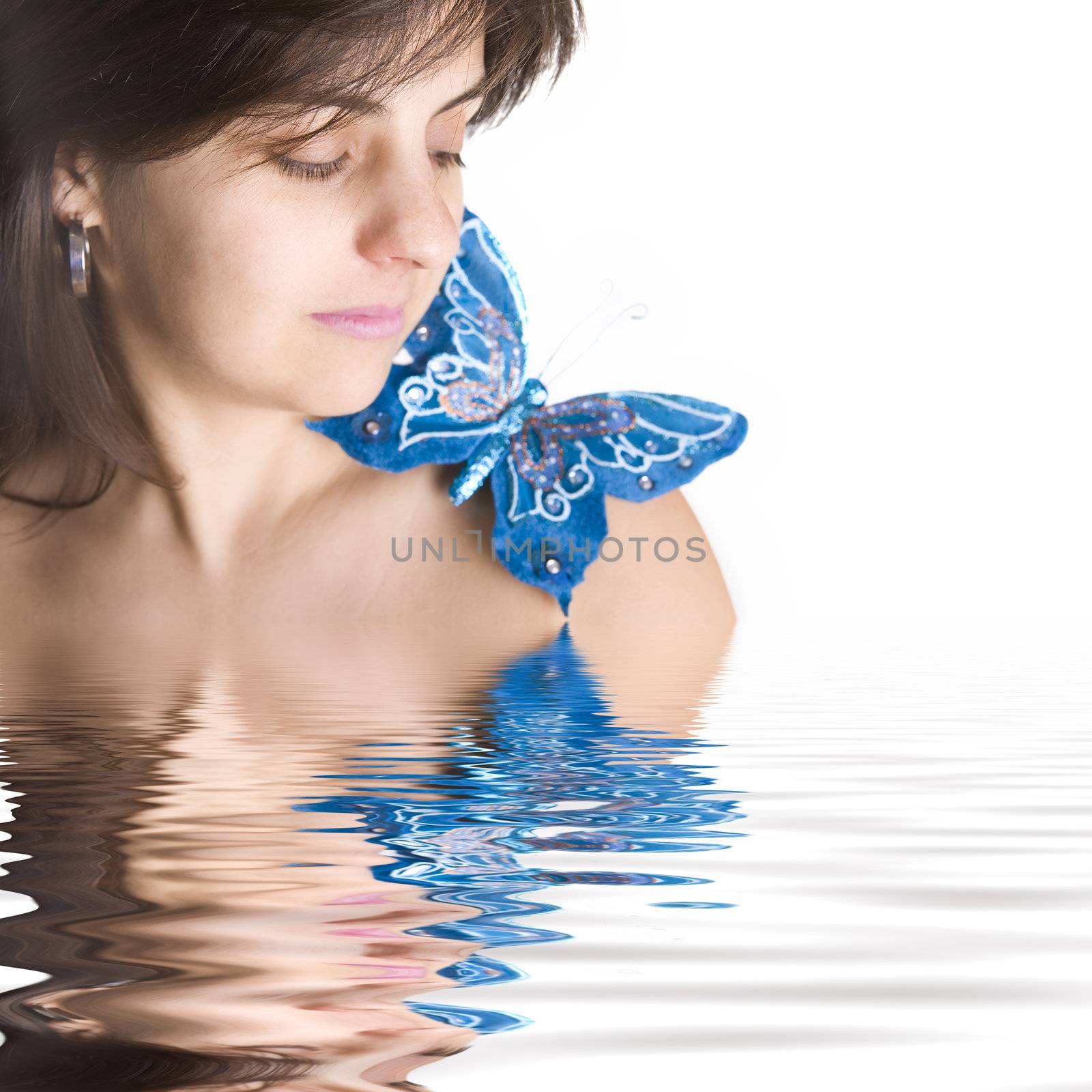 beautiful young woman with blue butterfly in her naked shoulder - focus on the eye