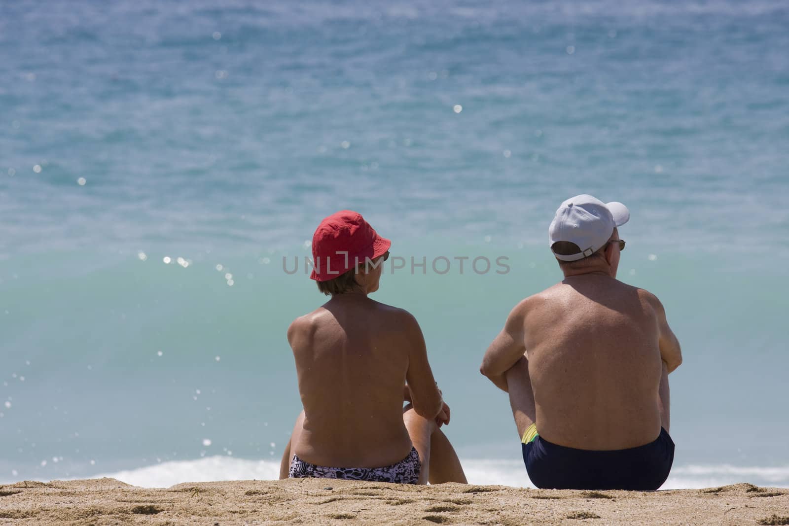 couple relaxing at the beach by ctacik