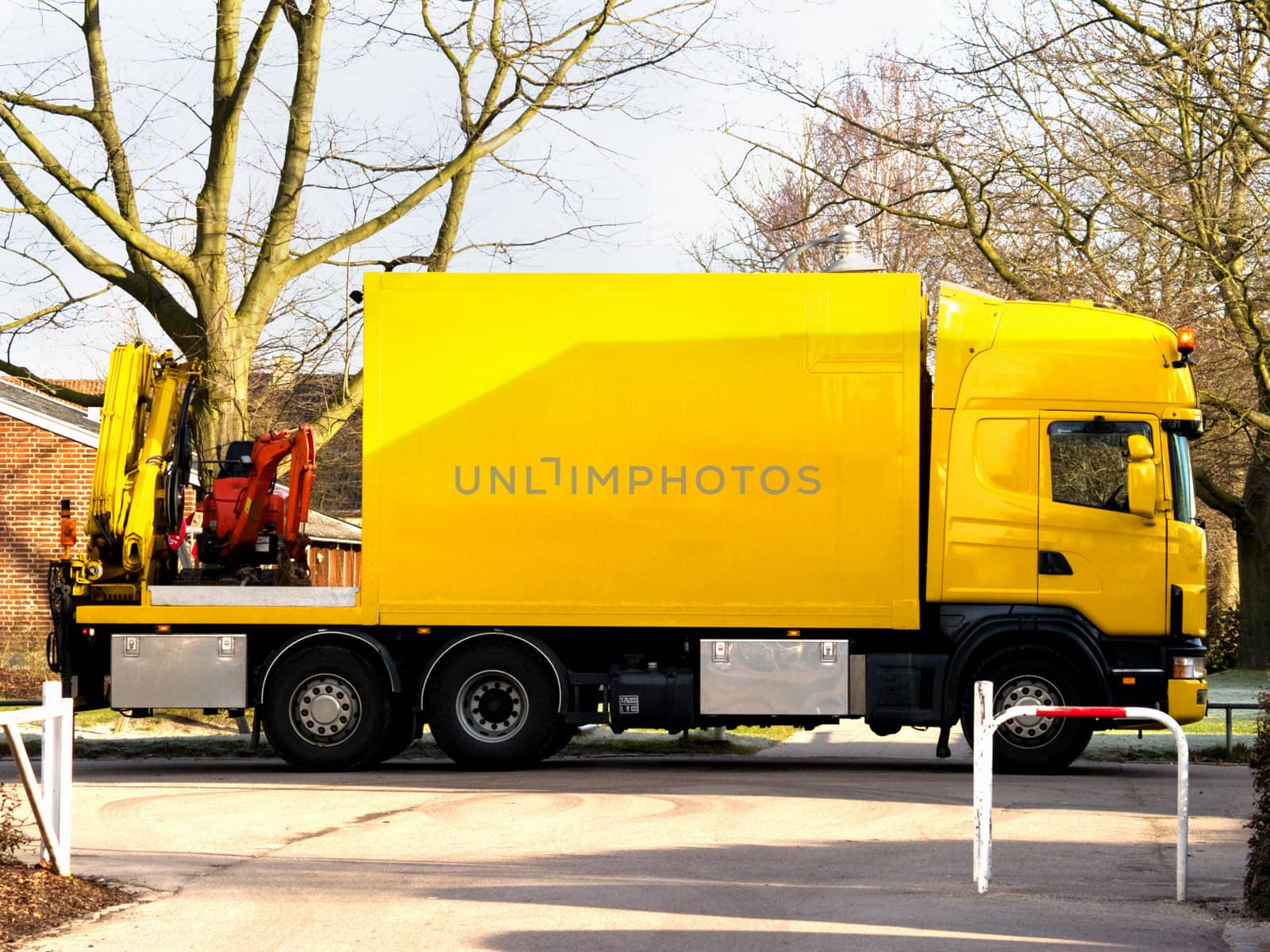 Yellow truck with mini excavator  urban