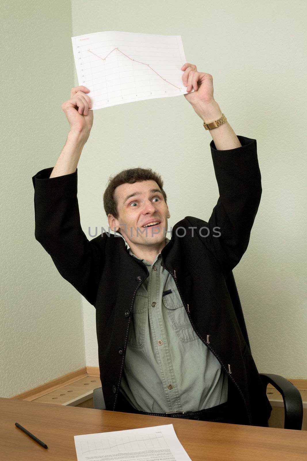 Director on a workplace with a graph in a hand