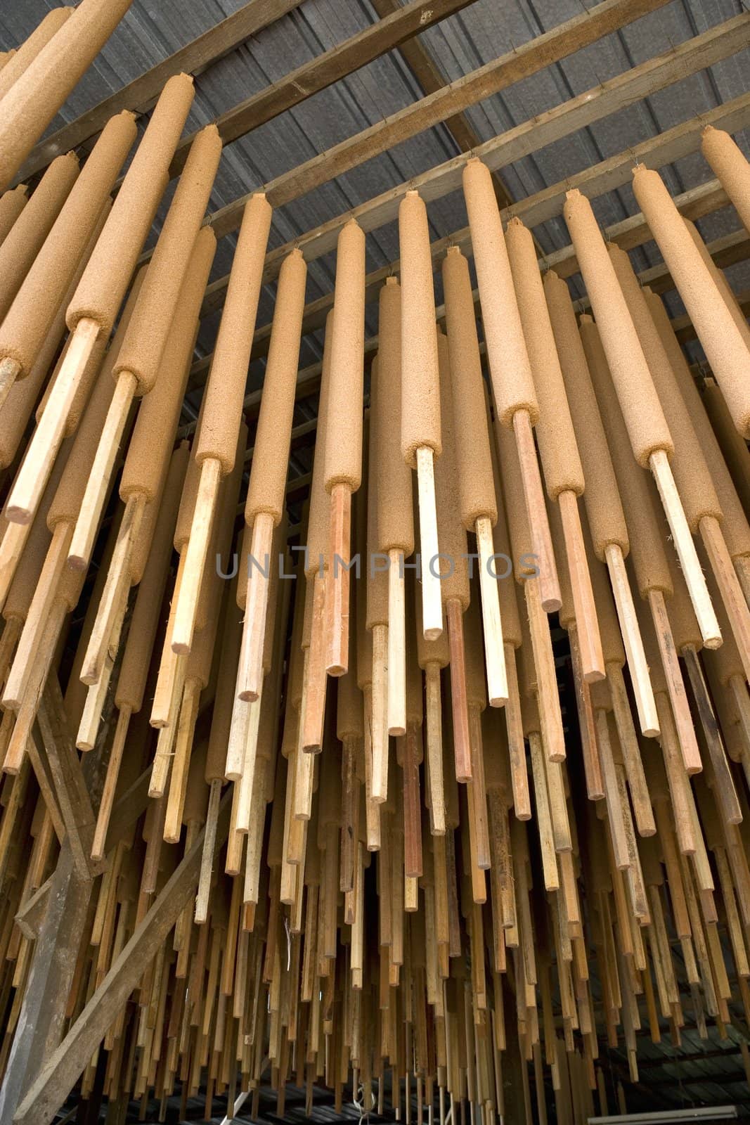 Image of joss sticks being hang dried at a factory in Malaysia.