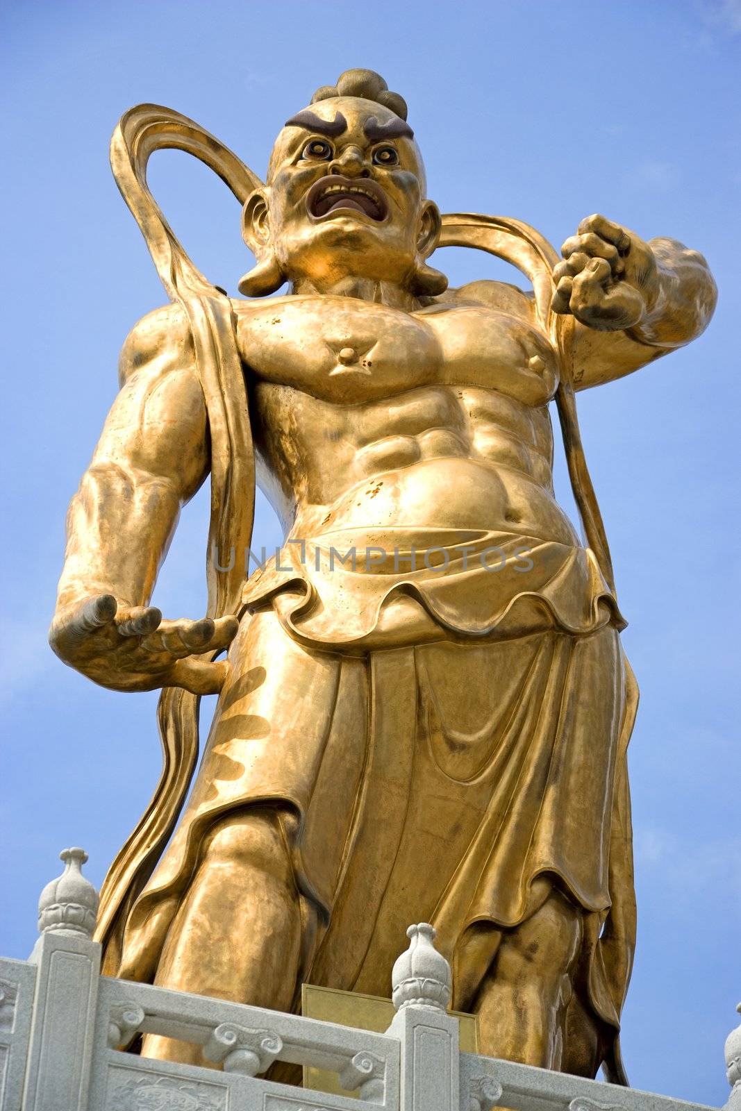 A giant statue of a guardian gurading the entrance to a Chinese temple in Malaysia.