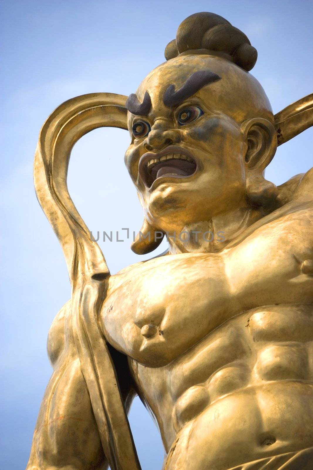 A giant statue of a guardian gurading the entrance to a Chinese temple in Malaysia.