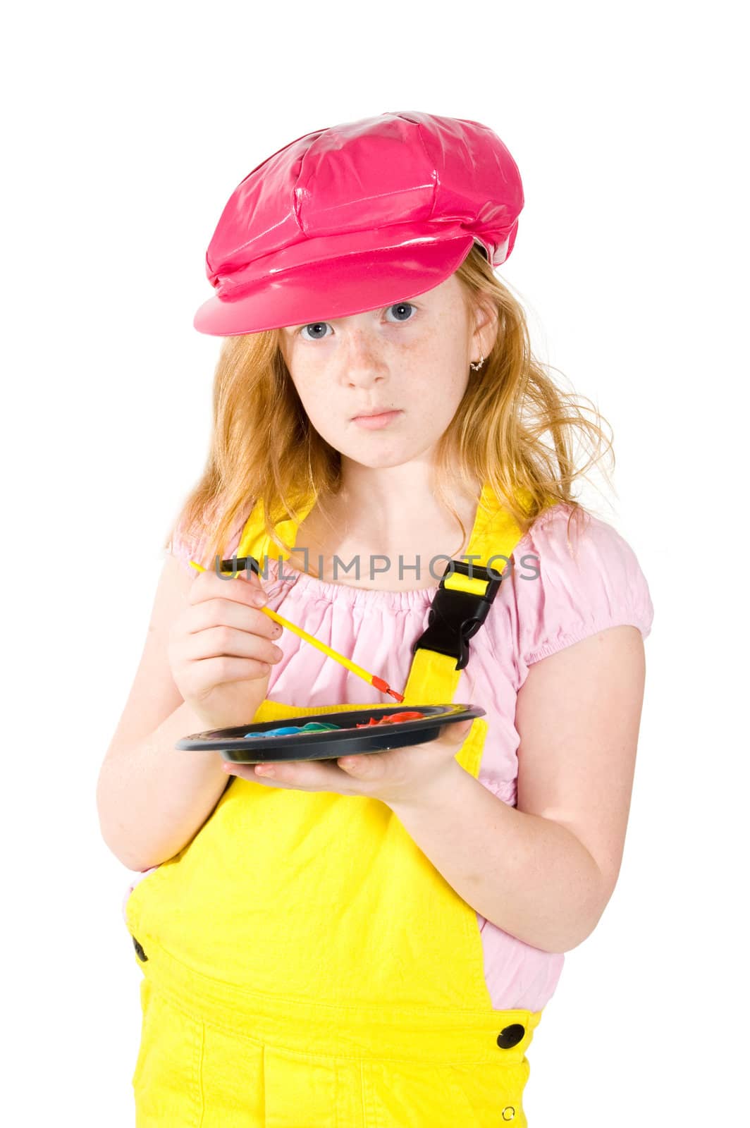 little girl is painting on a white paper isolated