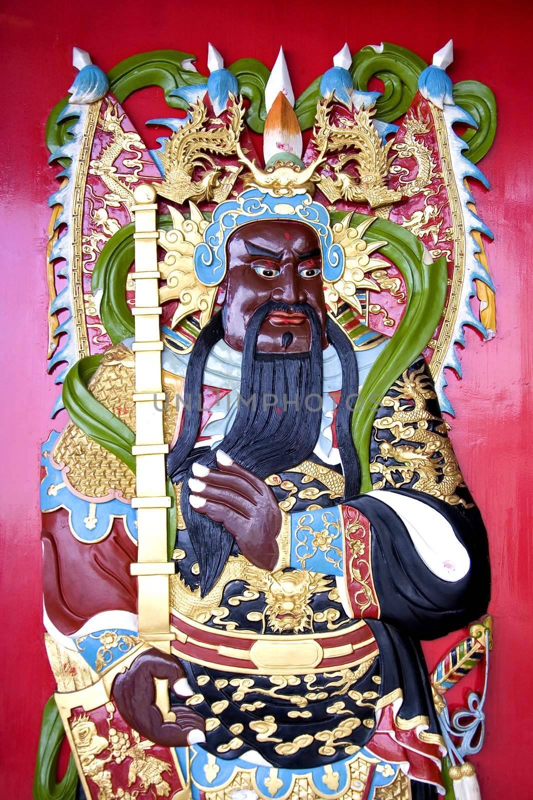 Image of a deity on a Chinese temple door.