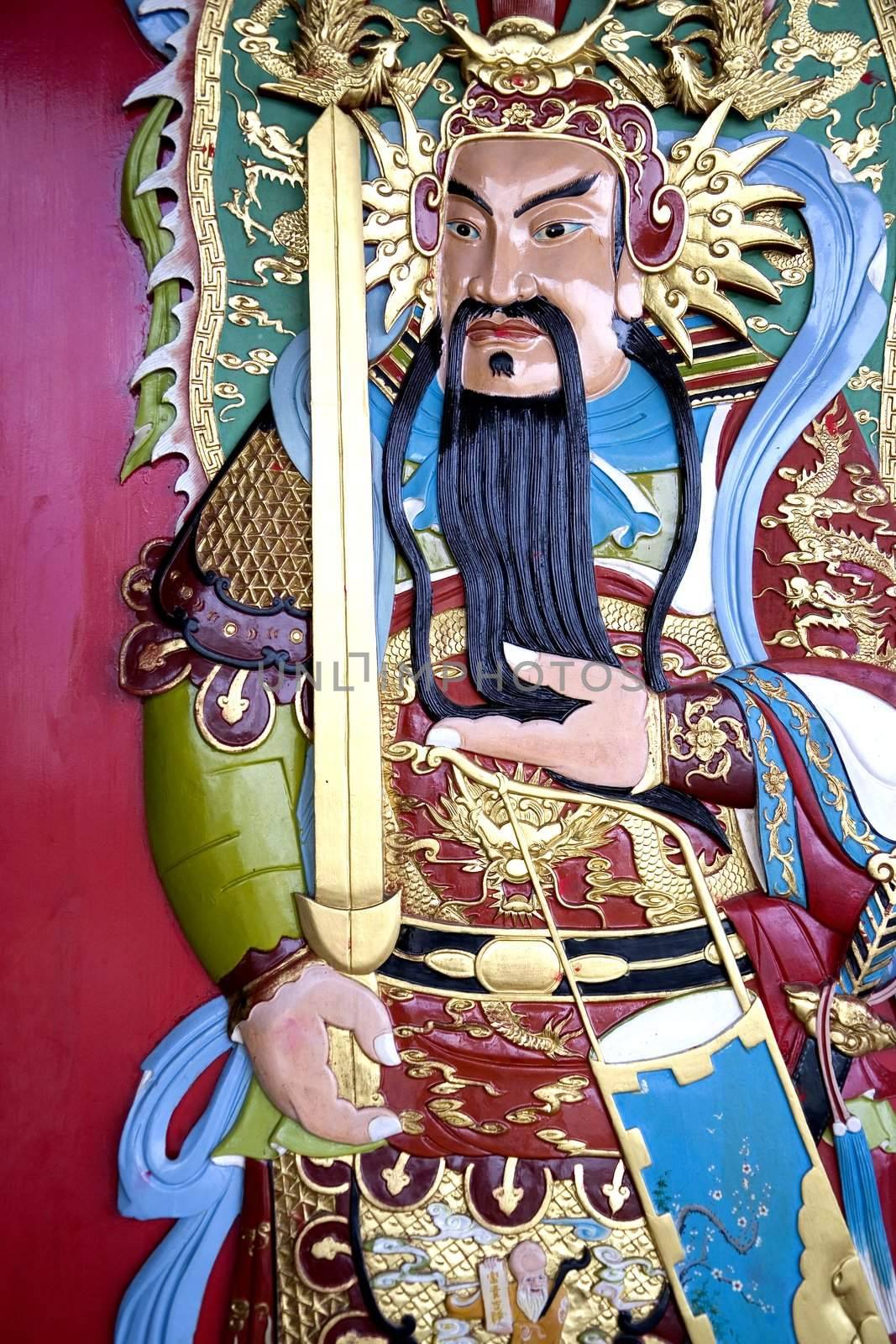 Image of a deity on a Chinese temple door.