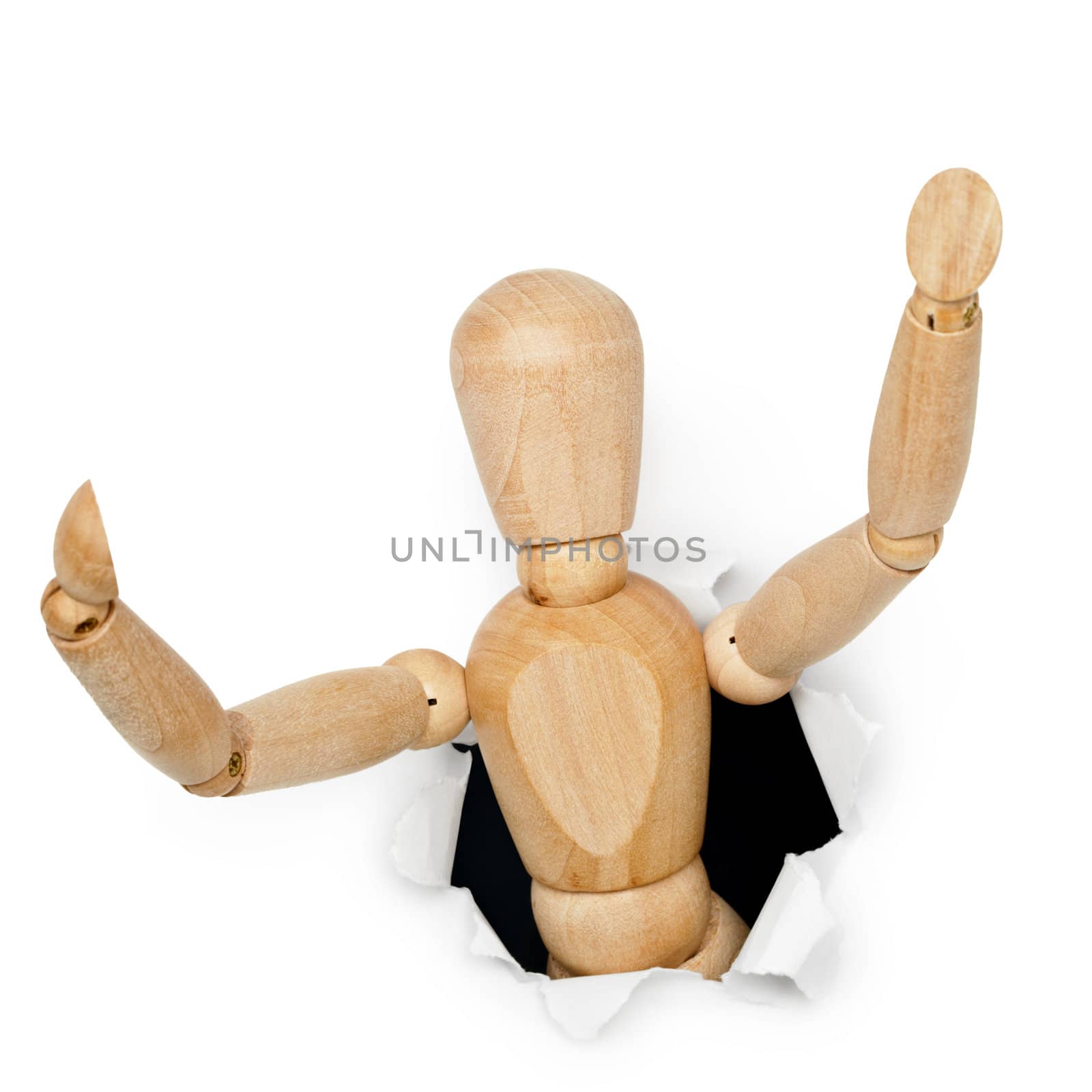 Wooden toy man looks out of the hole isolated on white background