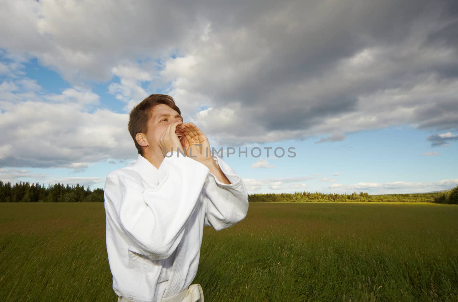 A man shouting into a field - summer day