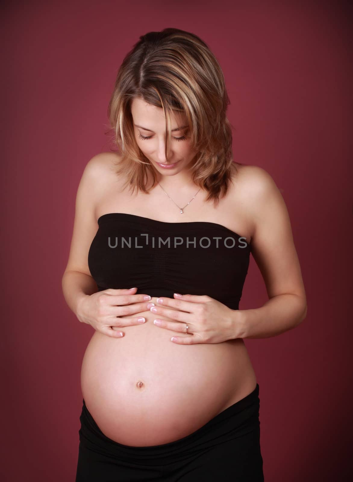 beautiful pregnant looking at her belly