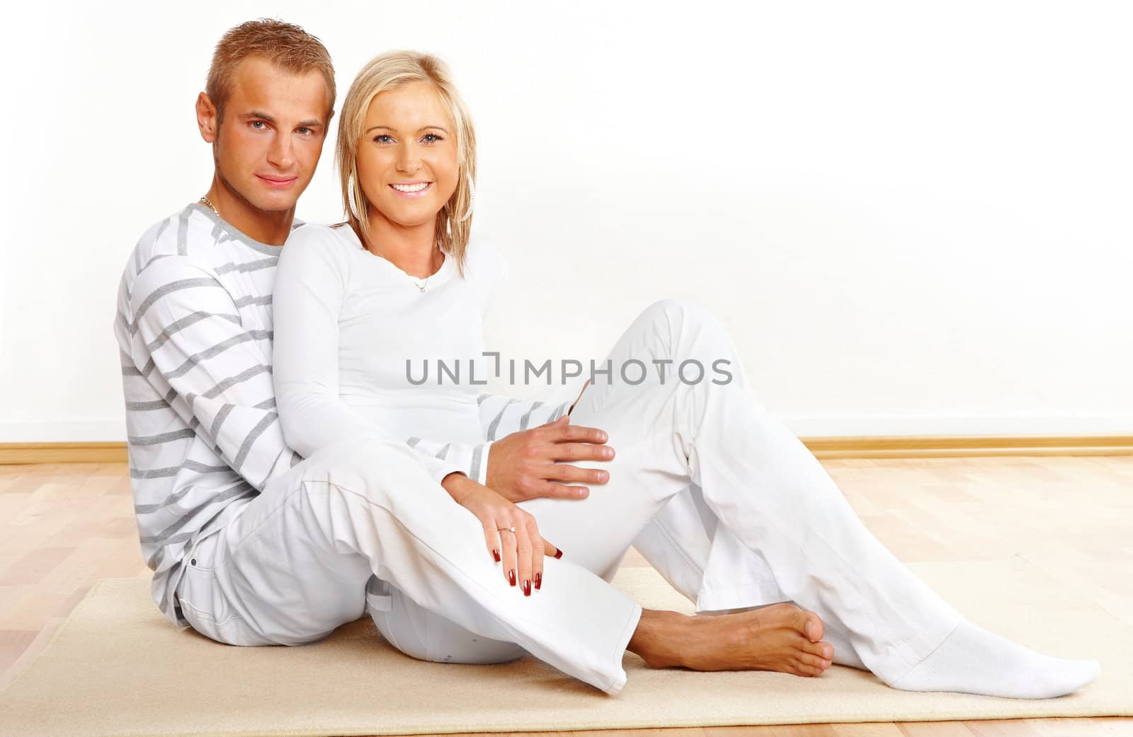 Portrait of a happy couple sitting in home