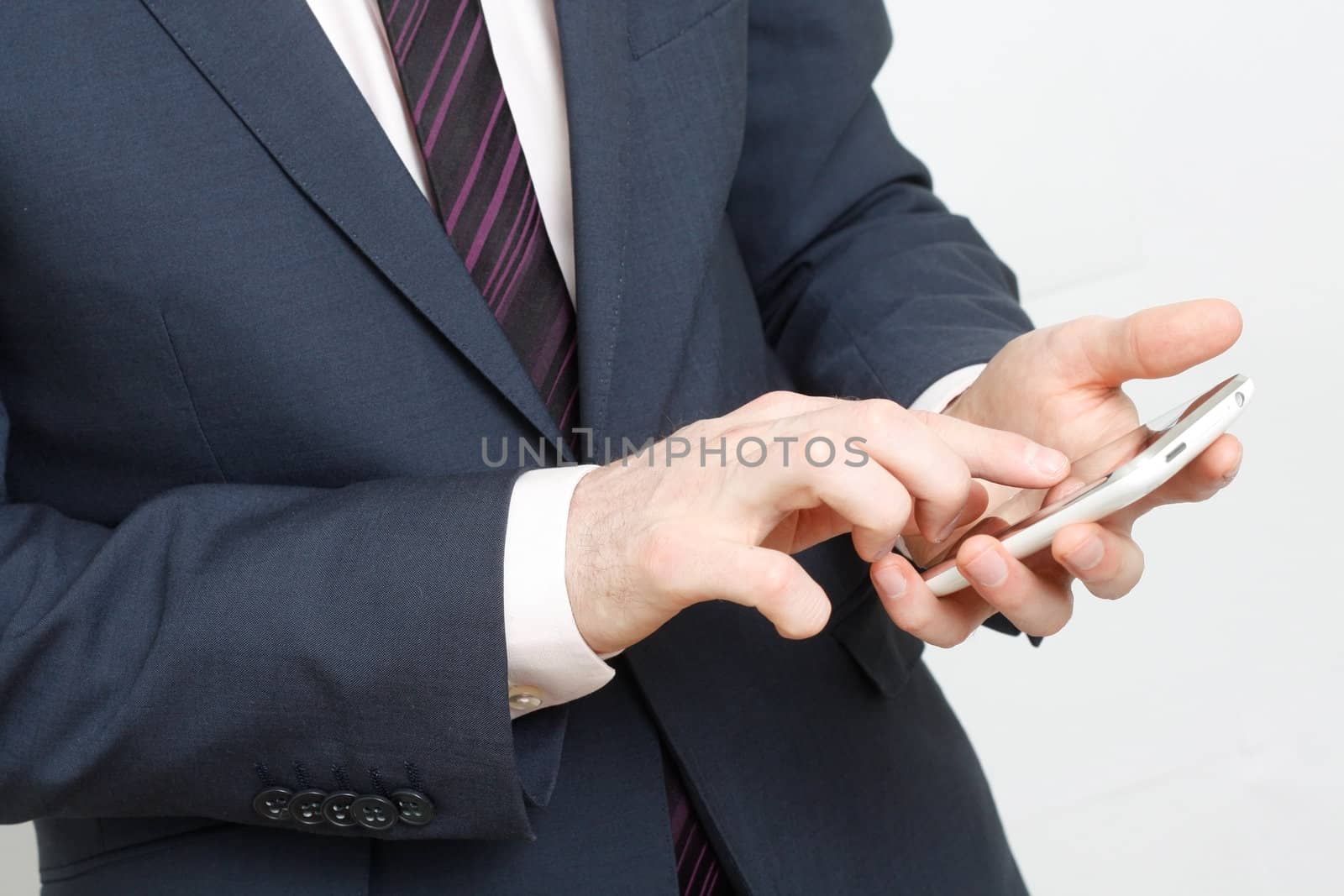 A business man typing on cell phone