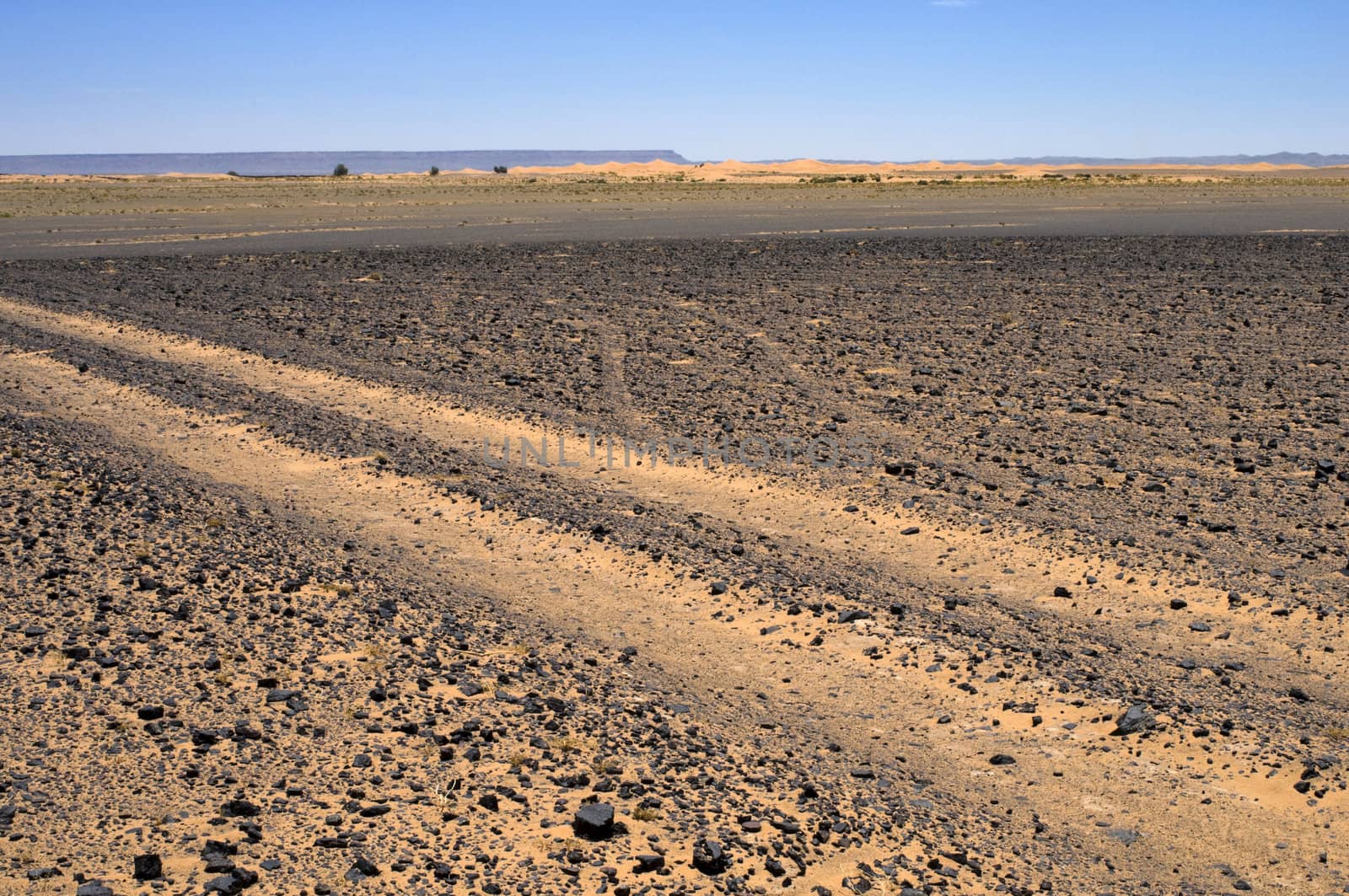 Trail in the sand and rocks Sahara desert - best of Morocco