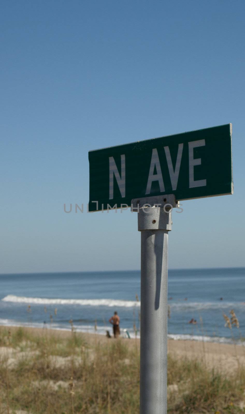 A road sign ending at the beach