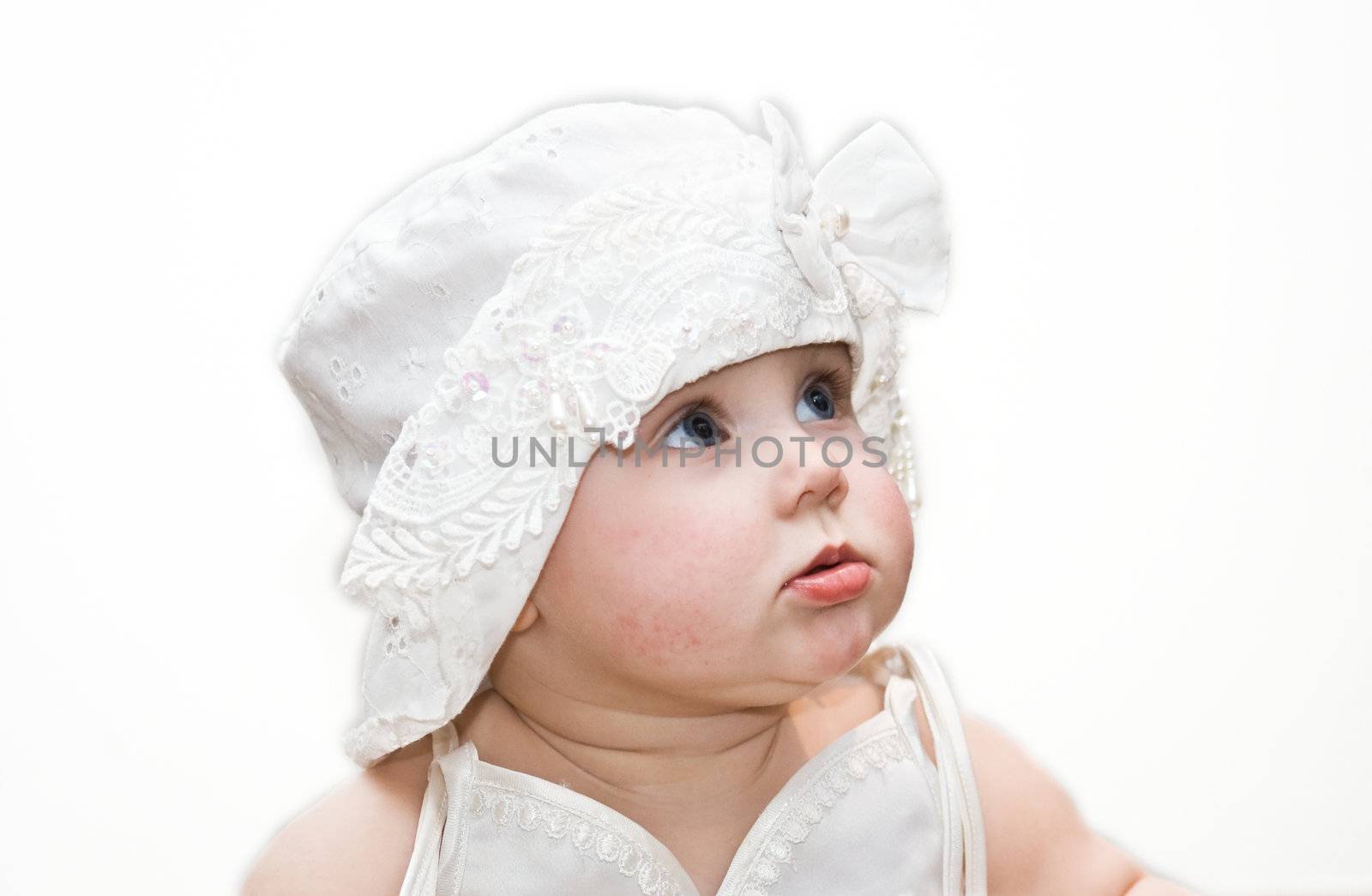 10 months old girl in nice dress and hat on white