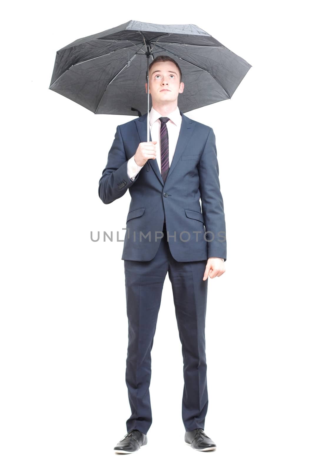 Business man under umbrella by leeser