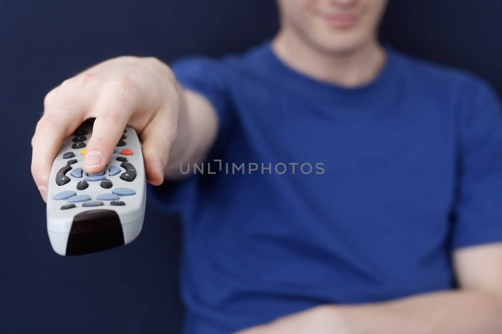 Guy watching tv with remote