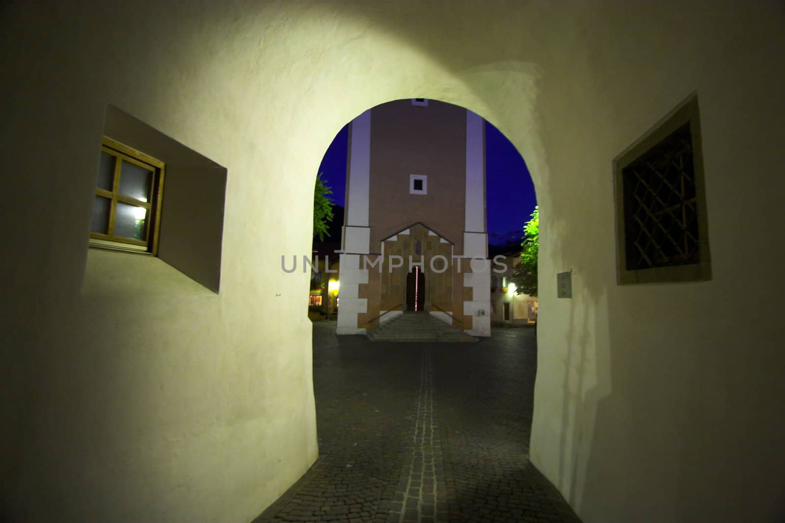 Church and passage under building at night