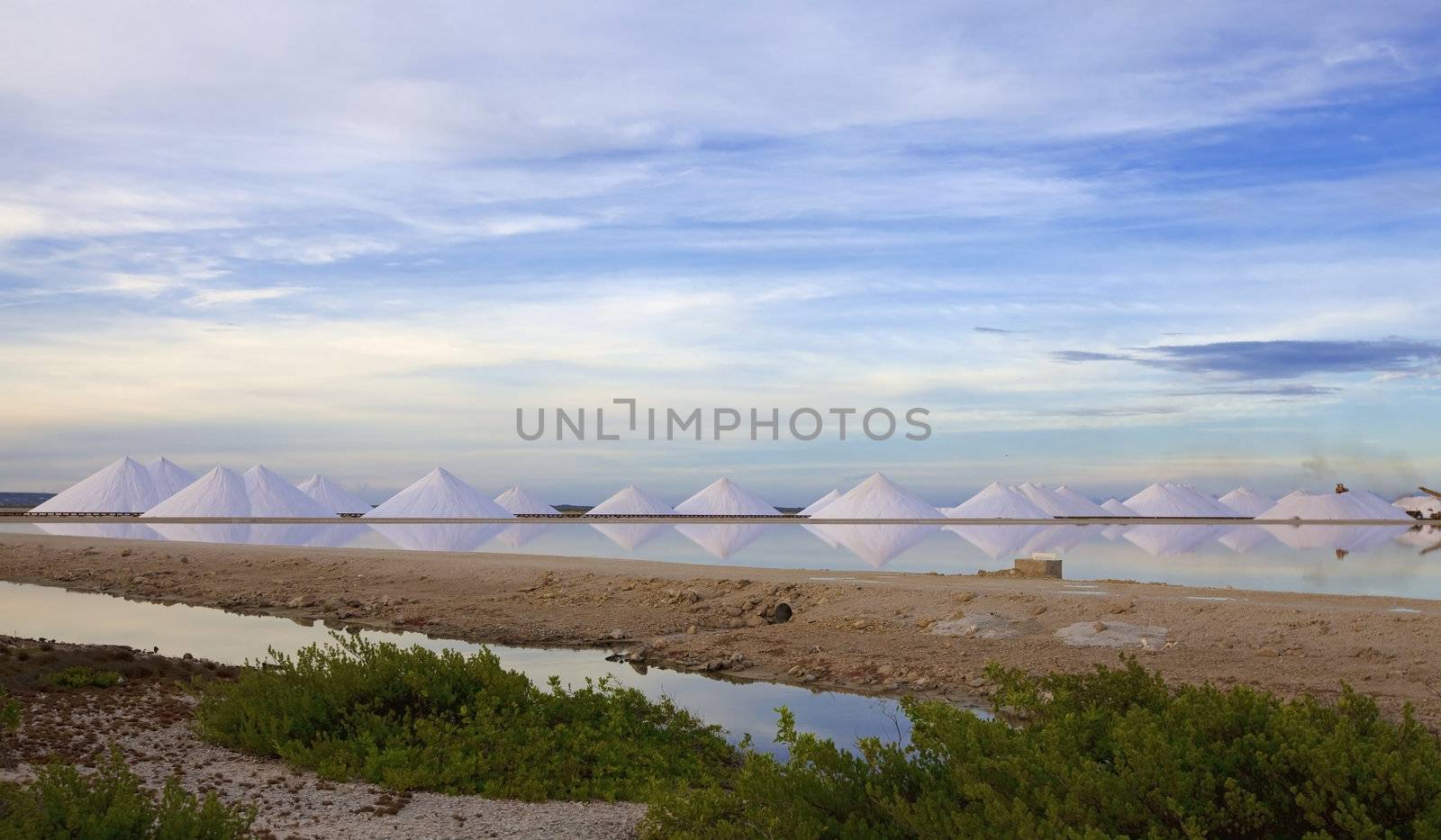 Salt mountains reflecting in the salt lake at Bonaire