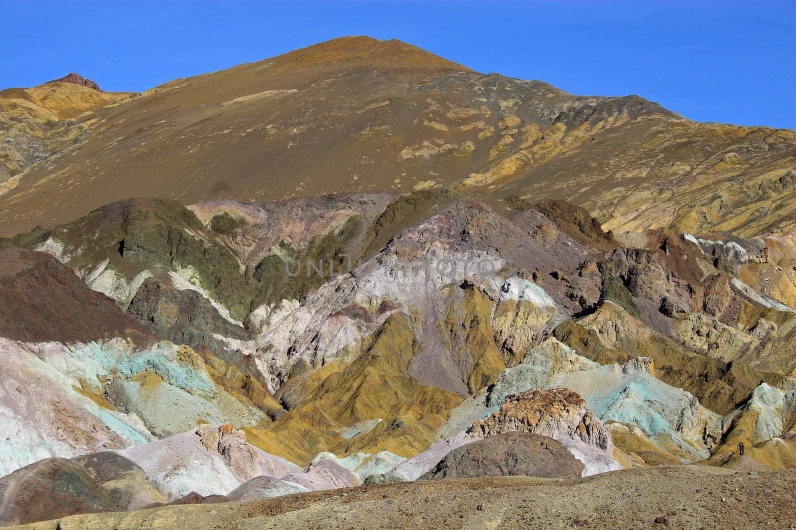 multicolored yellow, green purple and blue clay mineral deposits in geological formations of Death Valley National Park