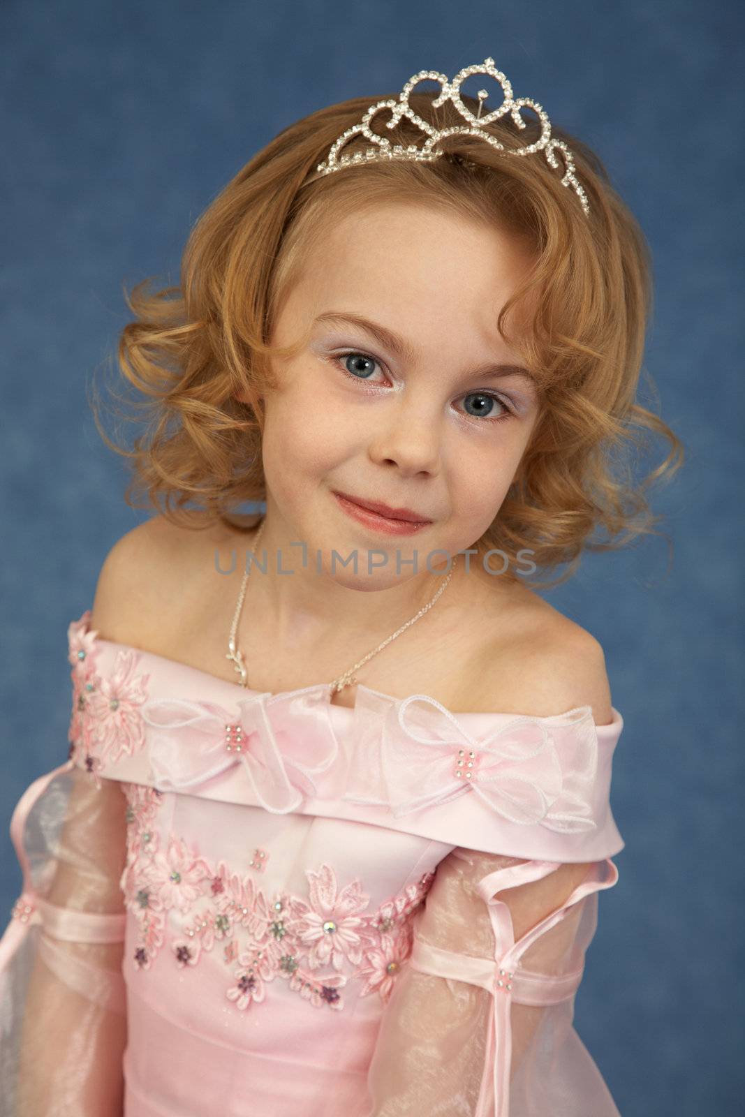 Portrait of a young girl in a pink dress